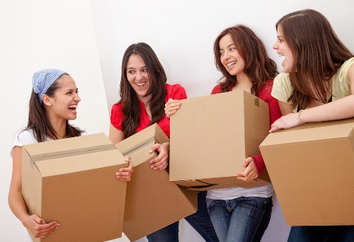Packed moving boxes and furniture in a Chiswick property