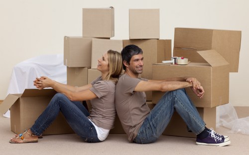 Professional movers unloading household items at a Chiswick property