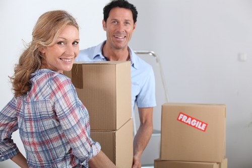 Moving team handling furniture and packed goods during a house removal job